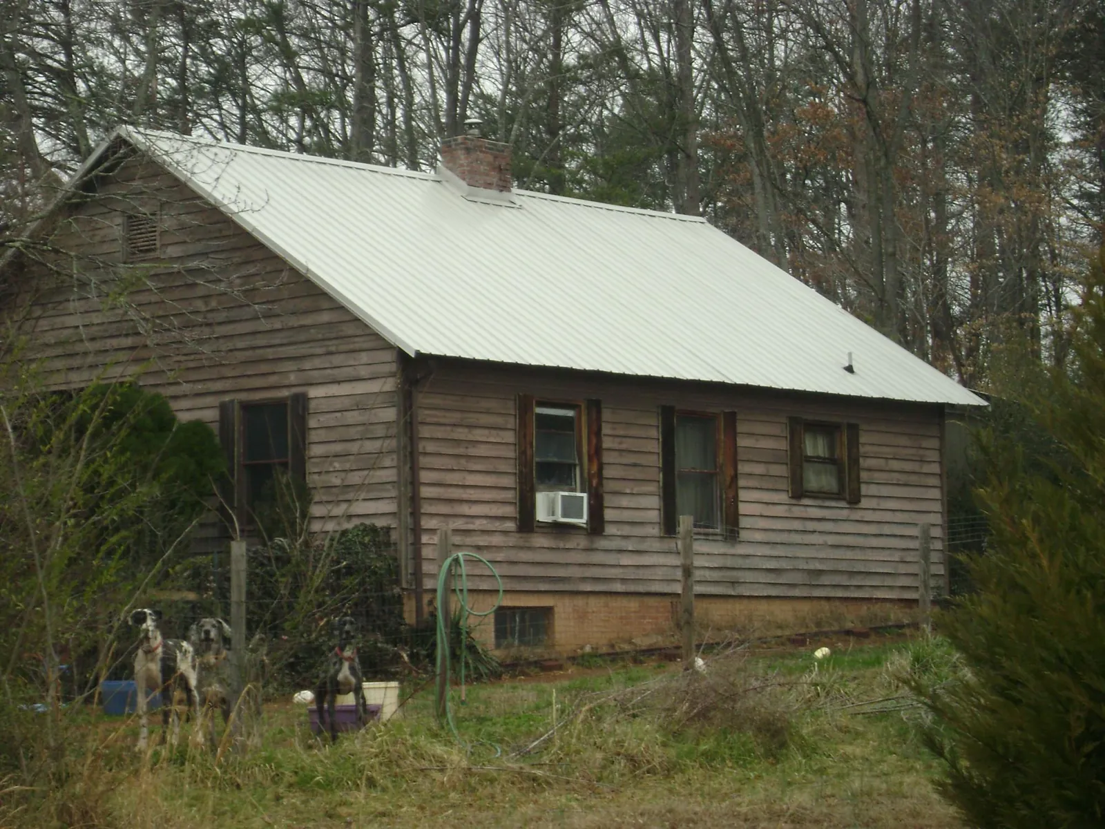 White metal roof on an old wood sided farmhouse, from a Metal Roof Installation job in Lincoln University